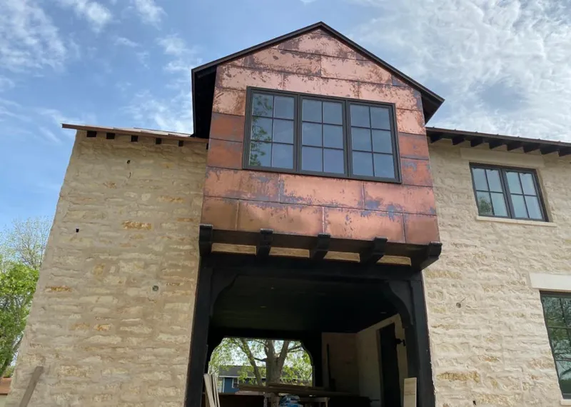 Copper metal panel facade on a stone building for Roof Repair in Palm River-Clair Mel