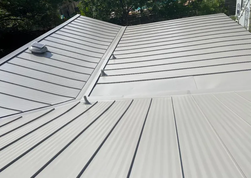 Solar attic fan installed on a metal roof for Roof Ventilation in Palm River-Clair Mel